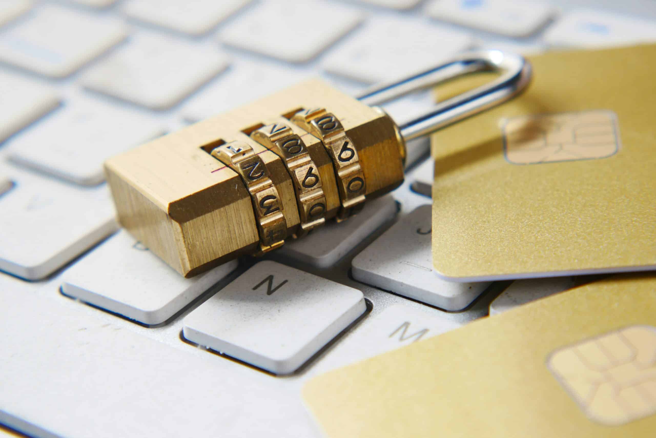 a keyboard with a lock and two credit cards